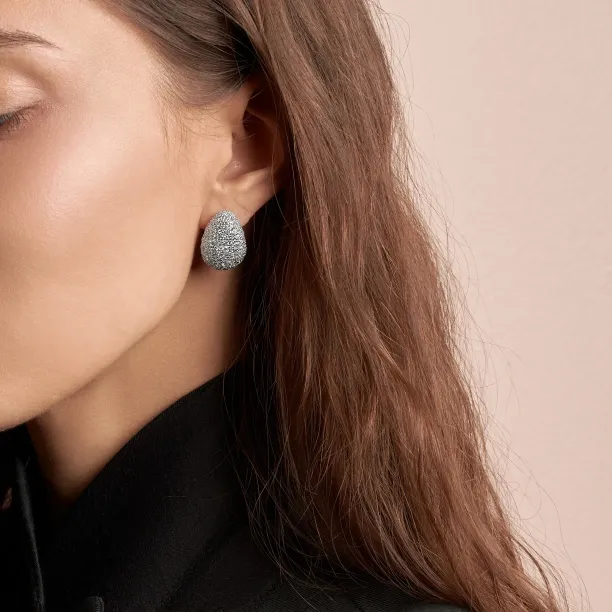 AMALIA gold earring with lab-grown diamonds worn on the ear, close-up