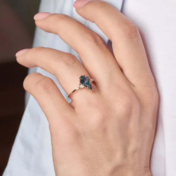 KATE ring with a lab-grown sapphire and moissanites worn on a finger