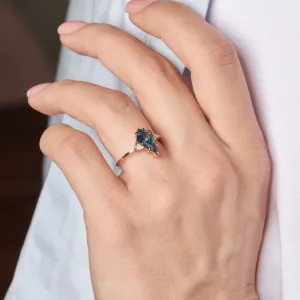 KATE ring with a lab-grown sapphire and moissanites worn on a finger