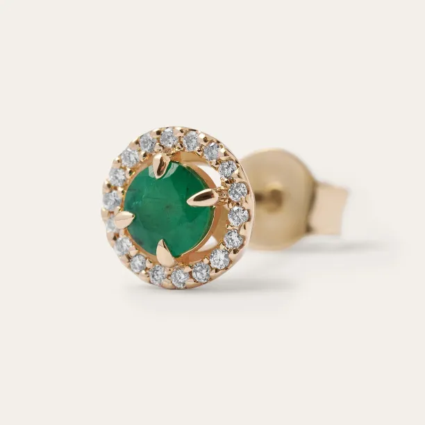 Close-up of one MOLLY emerald and diamond earring with an emerald center