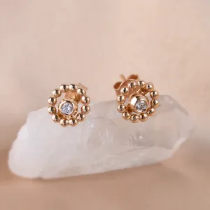 Angled view of rose gold FLOS stud earrings with removable gemstones