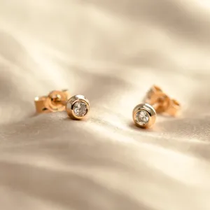 FLOS gold stud earrings with lab-grown diamonds shown without frames