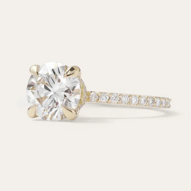 Angled view of the ARABELLA ring with a cushion-square center stone and diamond-set band