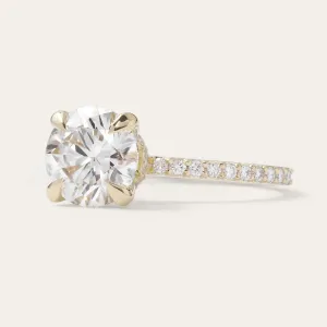 Angled view of the ARABELLA ring with a cushion-square center stone and diamond-set band