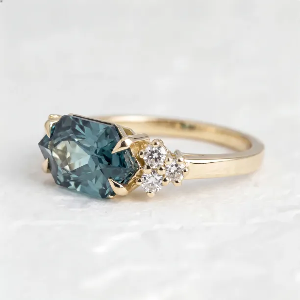 Angled close-up of the ARMINE gold ring with lab grown sapphire and diamonds