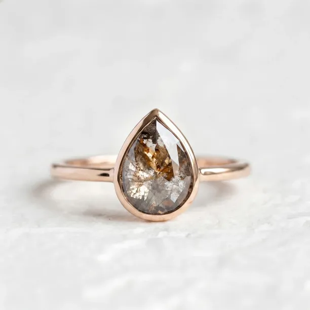 XENA gold ring with a salt and pepper diamond in a rounded teardrop shape