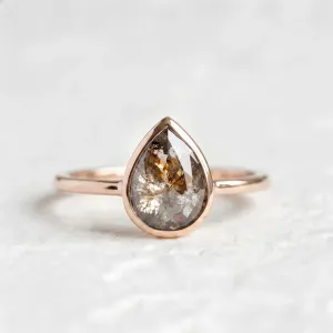 XENA gold ring with a salt and pepper diamond in a rounded teardrop shape