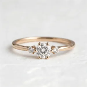 Close-up of the ALICIA gold engagement ring with three diamonds